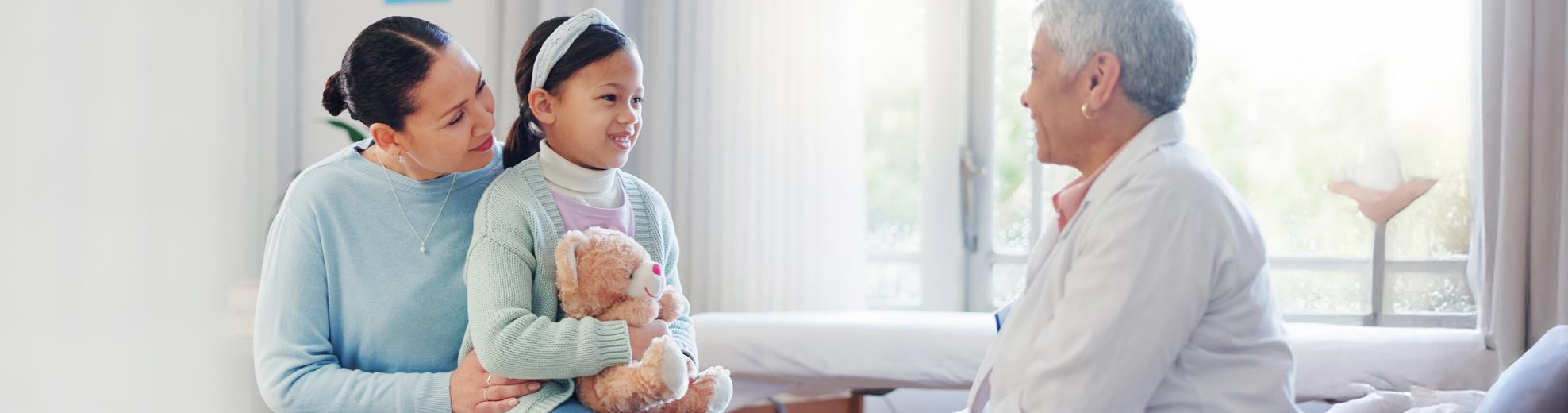 child and mother consulting doctor about immunizations