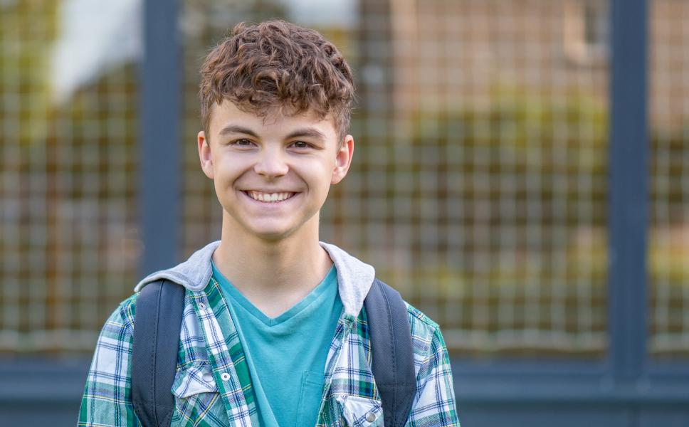Smiling preteen with a backpack in Lyon County